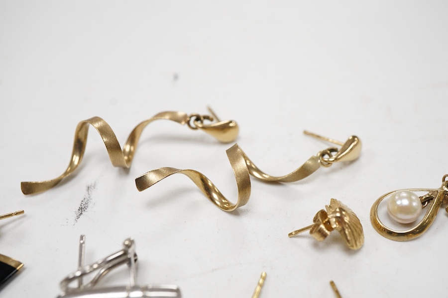 Three modern pairs of 9ct gold earrings, including spiral, triangular and moonstone set, together with five odd earrings.